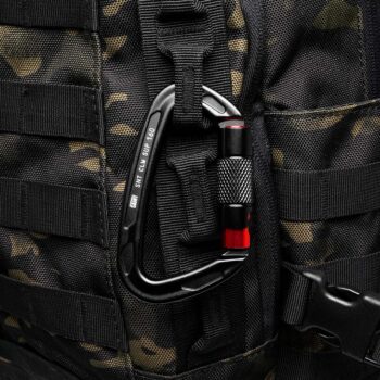 Military grade carabiner clipped to MOLLE backpack
