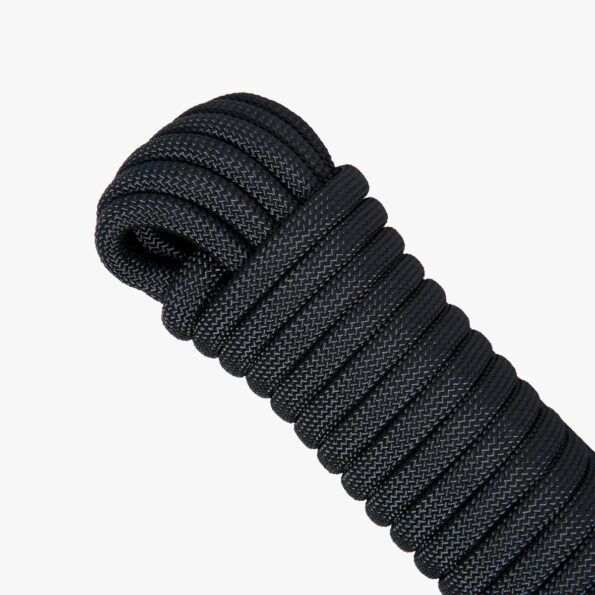 Coiled black 10 mm SAINT static rope on white background