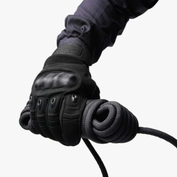 Gloved hand holding coiled black 10 mm SAINT static rope