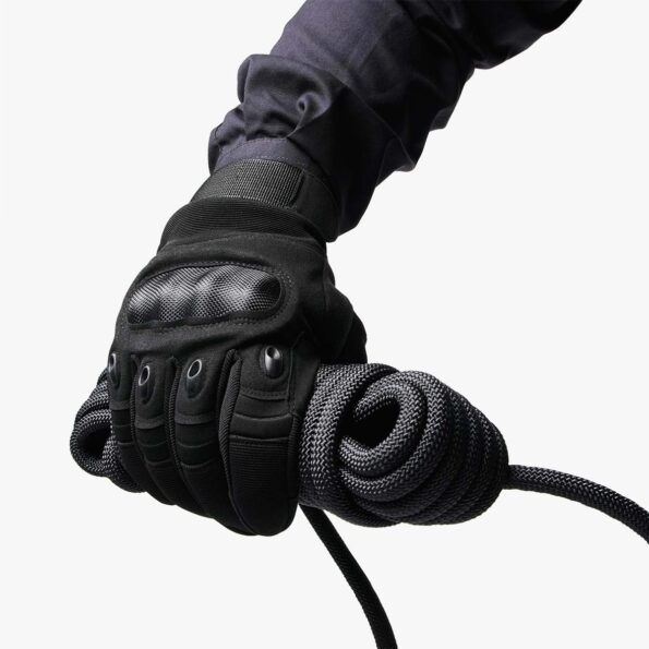 Gloved hand holding coiled black 10 mm SAINT static rope