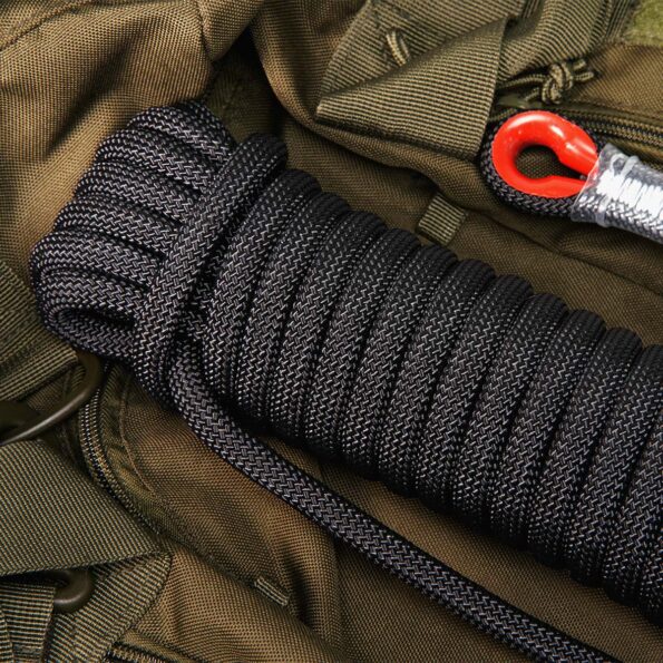Black 10 mm SAINT static rope coiled on tactical gear with red carabiner eyelet