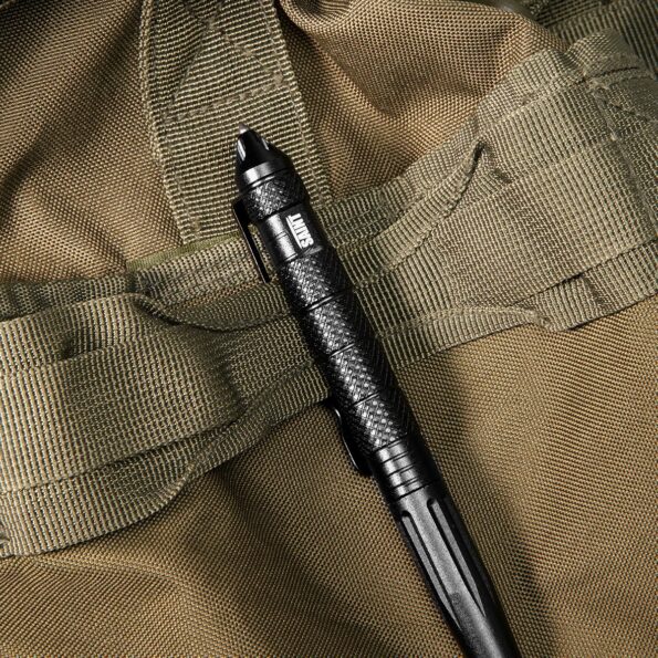 Tactical pen securely attached to khaki MOLLE webbing