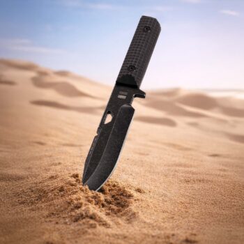 Rhino tactical knife stuck deep in hot desert sand